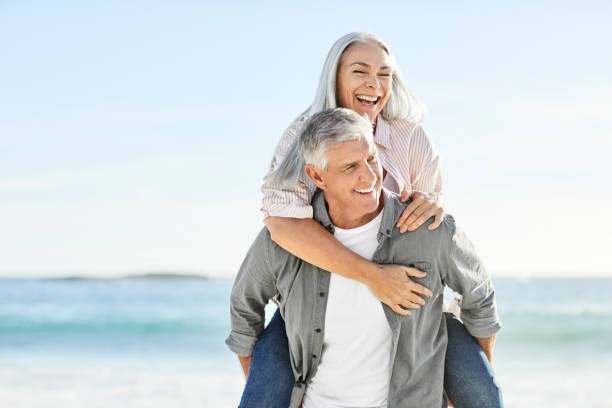 istock Happy heterosexual couple at beach during vacation 1283520919