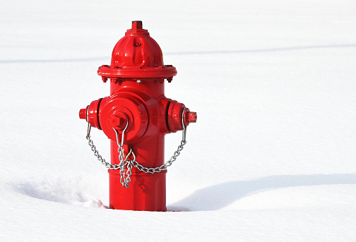 New red hydrant in recent snowfall.