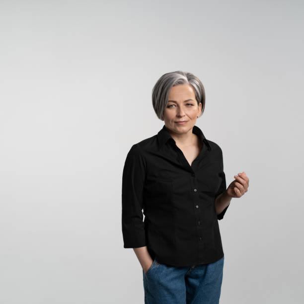 istock mature business woman smiles slightly looking at side 1283522321