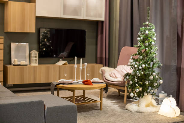 istock Cozy bright living room decorated with a Christmas tree with silver balls. 1283524702