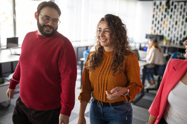 istock Young coworkers discussing about business at modern office 1283526557