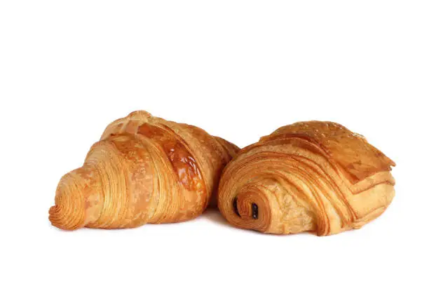 Photo of French croissant and petit pain au chocolat on white background.