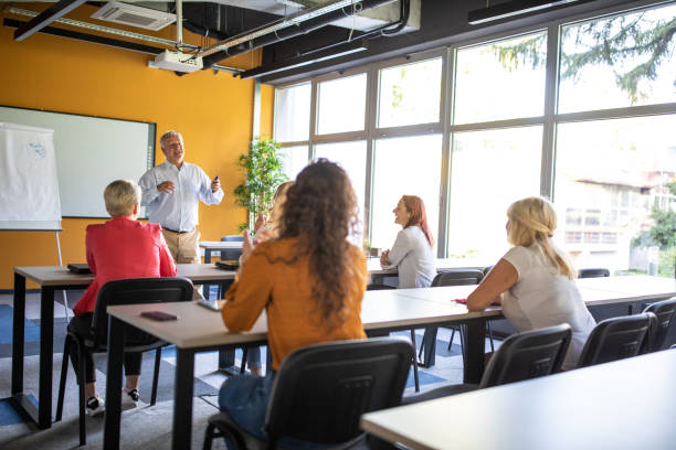 istock Businessman speaking in front of audience during education training class 1283527513