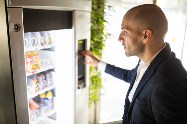 istock Businessman buying some snack from vending machine 1283527649