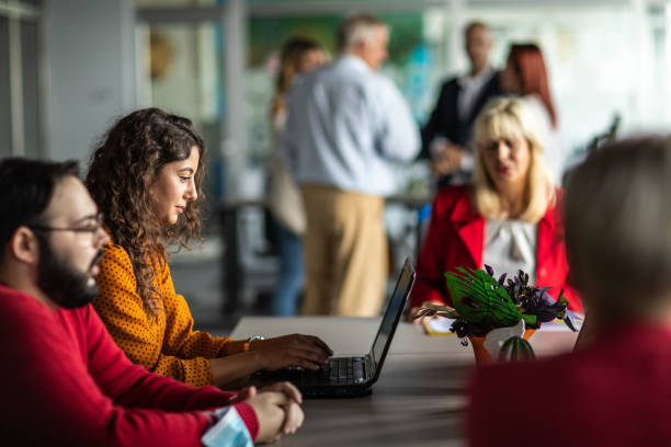 istock Business woman using laptop in open space office 1283527800