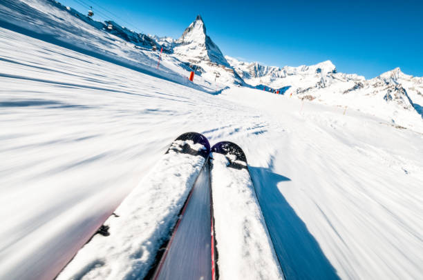 Skiing at speed A skier's perspective on a ski piste at speed, with motion blur in the foreground. back country skiing photos stock pictures, royalty-free photos & images