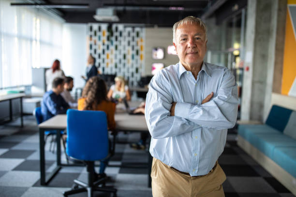 istock Confident senior businessman in modern coworking space 1283528361