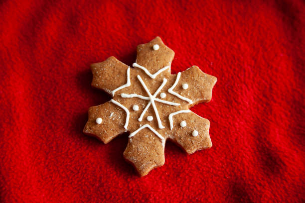 istock Christmas snow shaped cookies on red fabric background 1283528484