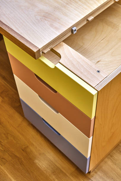 istock Plywood desk with multi color drawers during assembly. Close-up 1283530586