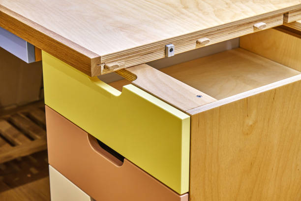 istock Plywood desk with multi color drawers during assembly. Close-up 1283530648