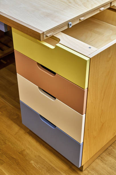 istock Plywood desk with multi color drawers during assembly 1283530663