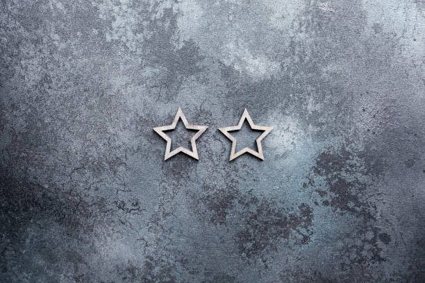 istock Two stars in a line on a dark textured background 1283531362