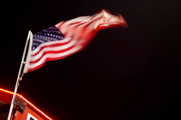United States flag with motion blur blowing at night with copy space