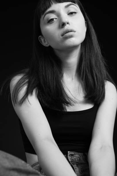 istock Studio portrait of a young woman against plain black background 1283531667