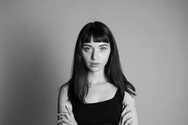 istock Studio portrait of a young woman against plain grey background 1283531668