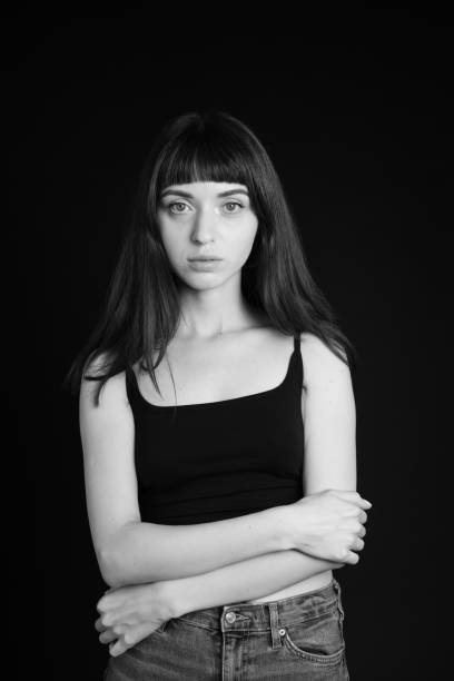 istock Studio portrait of a young woman against plain black background 1283531673