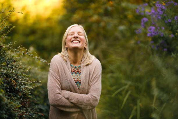 Middle age female breathing fresh air in a forest in fall