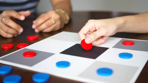 istock people playing tic tac toe board game strategy on wooden table top selected focus 1283532192