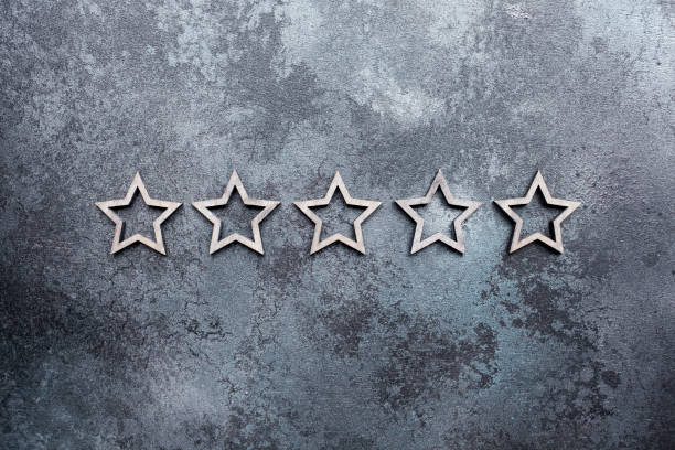 istock Five stars in a line on a dark textured background 1283534298