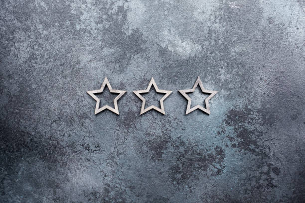 istock Three stars in a line on a dark textured background 1283534362