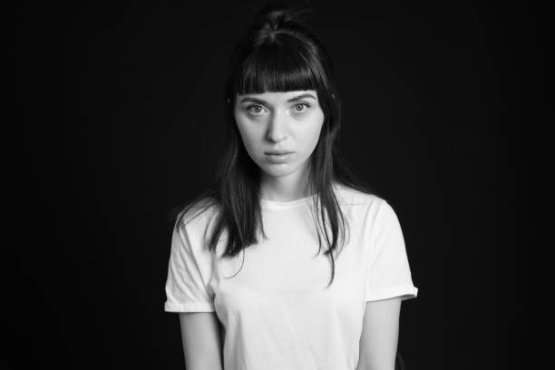 istock Studio portrait of a young woman against plain black background 1283535505
