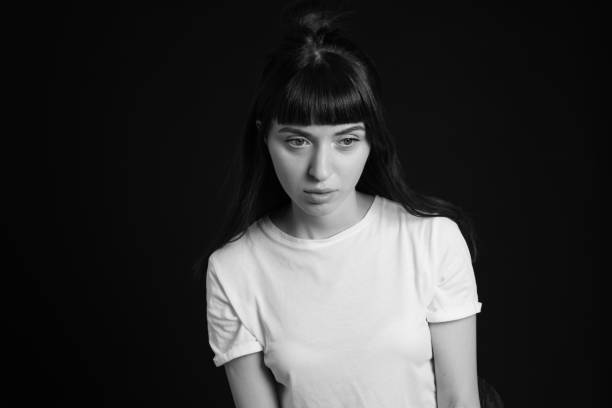 istock Studio portrait of a young woman against plain black background 1283535507