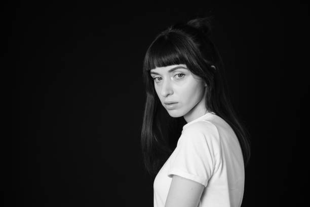 istock Studio portrait of a young woman against plain black background 1283535510
