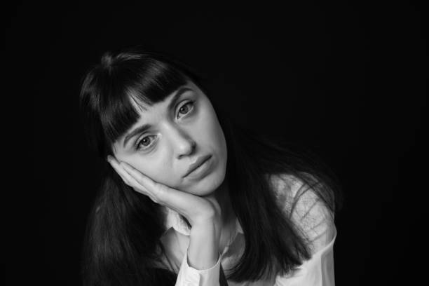 istock Studio portrait of a young woman against plain black background 1283535515