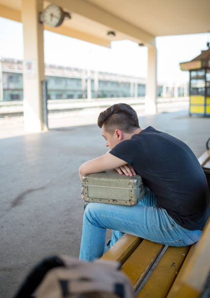 istock Man standing on the subway platform, waiting for his train 1283537818