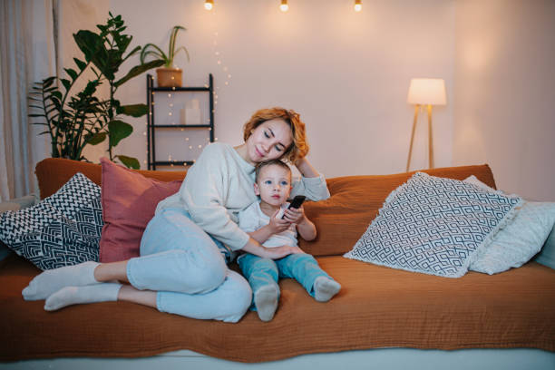istock Loving mom watching televesion with her little son. 1283538063