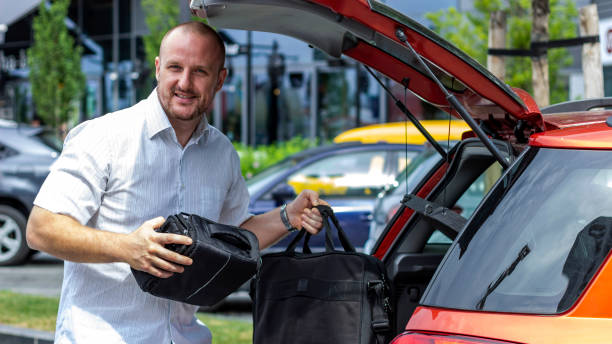 istock Man carrying bags from his car, looking away. 1283538678