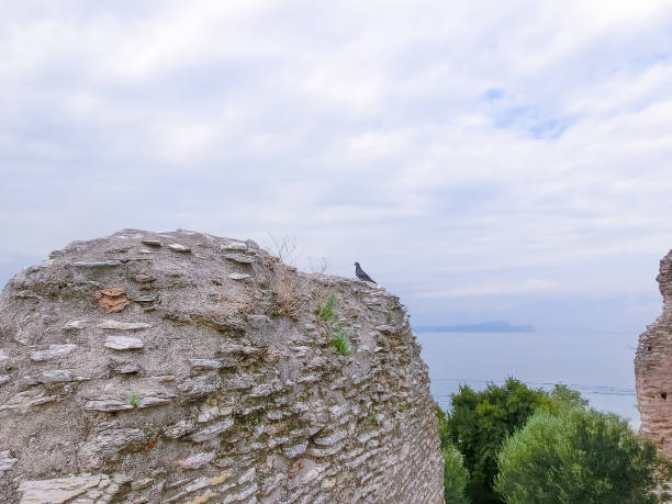 Ruins of Catullus Caves, roman villa in Sirmione, Garda Lake Sirmione, Italy - September 20, 2014: Ruins of Catullus Caves, roman villa in Sirmione, Garda Lake, Italy porticus stock pictures, royalty-free photos & images