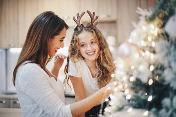 istock Two girls decorating Christmas tree. 1283539604