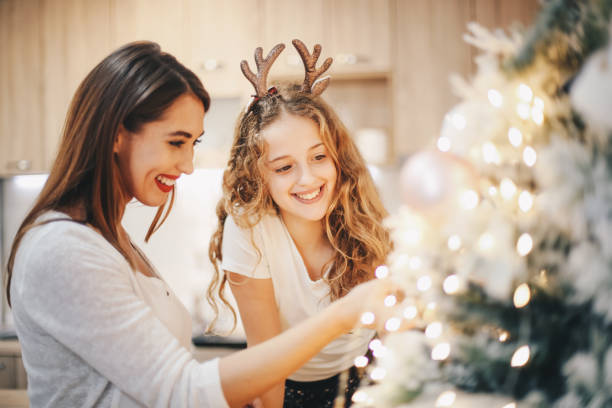 istock Two sisters are preparing Christmas tree for holiday. 1283539706