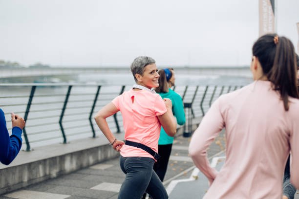 istock Group of women jogging and supporting each other 1283541856