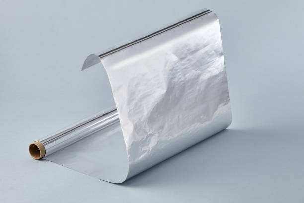 istock Aluminum foil roll on pastel blue background 1283542632