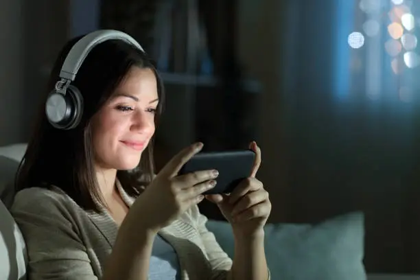 Photo of Relaxed woman watching video in the night at home
