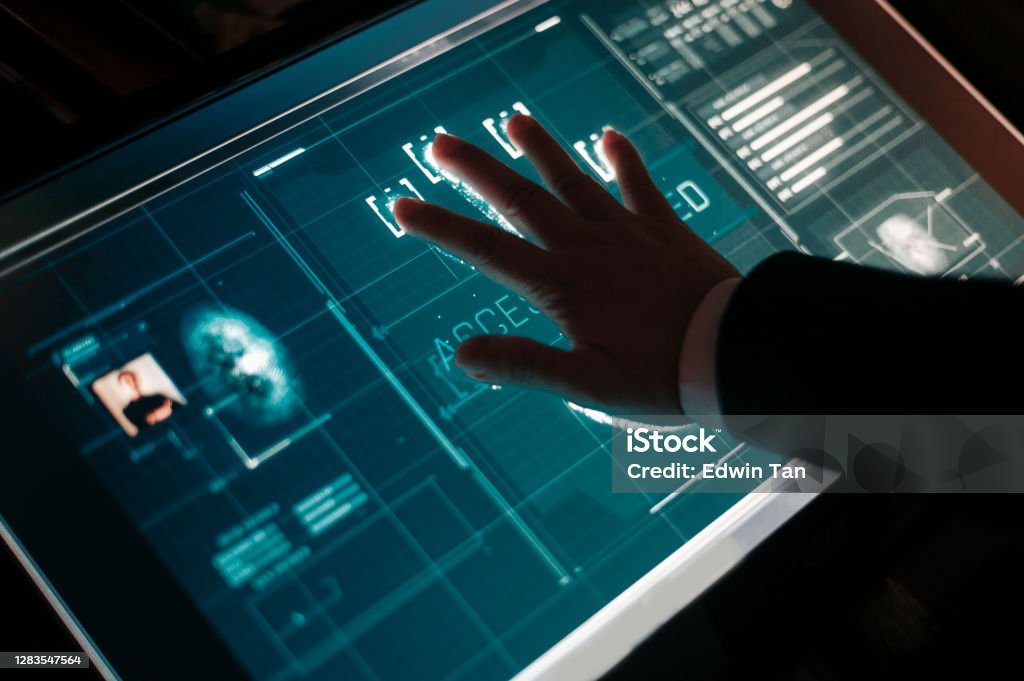 hand of asian chinese with blazer put on scanner device screen for security check access Network Security Stock Photo