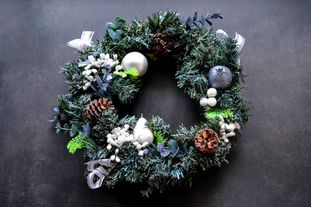 istock Artificial Christmas wreath with decorations of cones, white pear, bows and silver garnet 1283548735