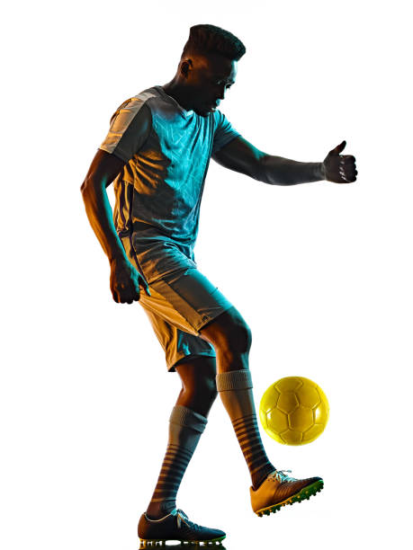 istock young african soccer player man isolated white background silhouette shadow 1283551303