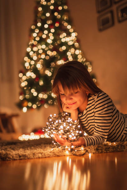 istock Child holding handful of Christmas lights 1283552597