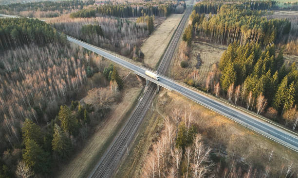 Truck carrying load on bridge Truck carrying load on bridge above drone view musical instrument bridge stock pictures, royalty-free photos & images