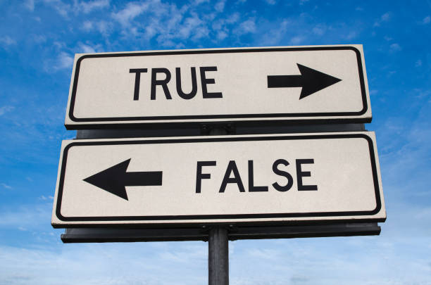 True vs false. White two street signs with arrow on metal pole with word. Directional road. Crossroads Road Sign, Two Arrow. Blue sky background. Two way road sign with text. stock photo