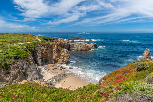 Wide view of waves crashing on shore rocks of Garrapata Beach.\n\nTaken at Garrapata Beach, Big Sur, California, USA