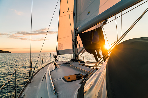 Golden sunset over the ocean captured from a sailing yacht in the baltic sea