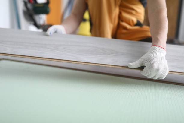 istock Gloved craftsman holds laminate board indoors closeup 1283554398