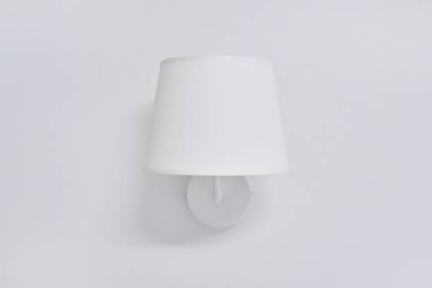 istock White elegant modern wall lamp with textile shade in interior 1283555023