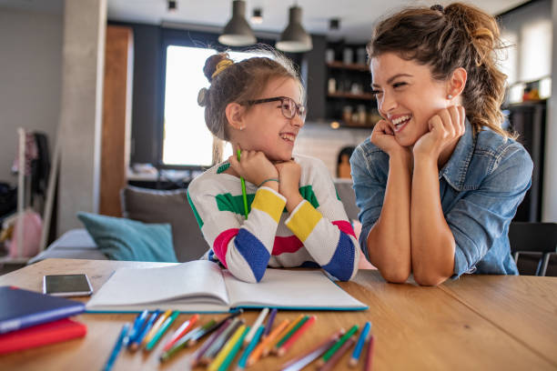 istock Young girl doing homework with her mother at home 1283555535
