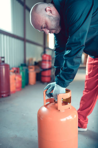 istock Worker Ready To Lift Liquified Gas Cylinder 1283555727