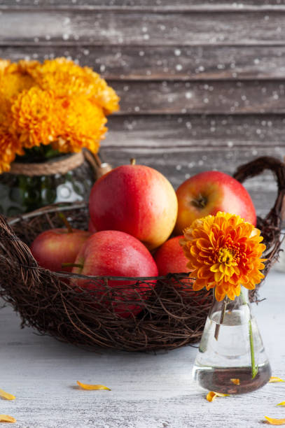 istock Ripe red apples and yellow chrysanthemum 1283556000